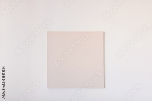 Blank square canvas on the wall. Picture, poster mockup, template. Art gallery.