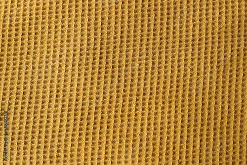 Fabric square knitted texture of mustard color.