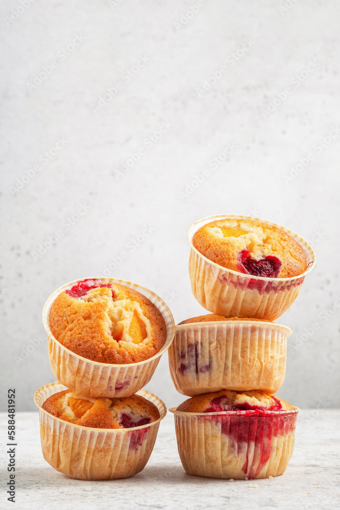 Baked Melba Raspberry Peach Muffins on a white background Baked Melba Raspberry Peach Muffins on a white background