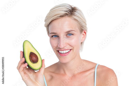 Pretty blonde holding half of an avocado 