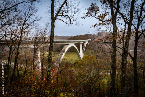 Natchez Trace Parkway Double Arch Bridge over Birdsong Hollow in Tennessee. Overlook with autumn foliage.  photo