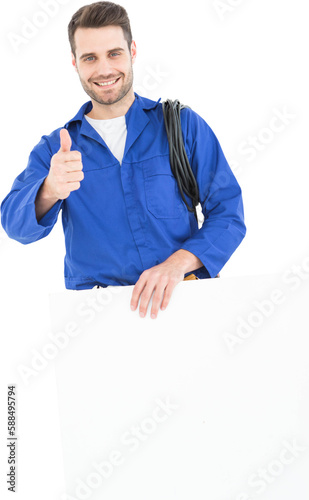 Happy repairman gesturing thumbs up while holding blank billboard