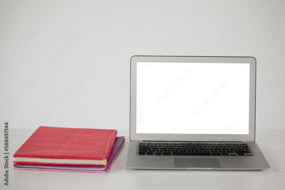 Books and laptop on table