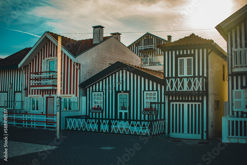 Aveiro, Portugal - 2023: Costa Nova do Prado typical beach houses with stripes of multiple colors. Touristic destination for people to take photos. Late at the afternoon in summertime.