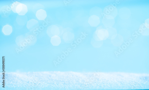 Snow on a blue background with light. Winter banner. © OLENA SANZHAREVSKA