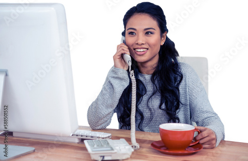 Smiling Asian woman on phone call holding mug