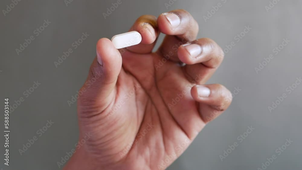Close up of man hand holding white color medical pills Close up of man hand holding white color medical pills