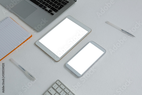 Various electronic gadgets and book on white background