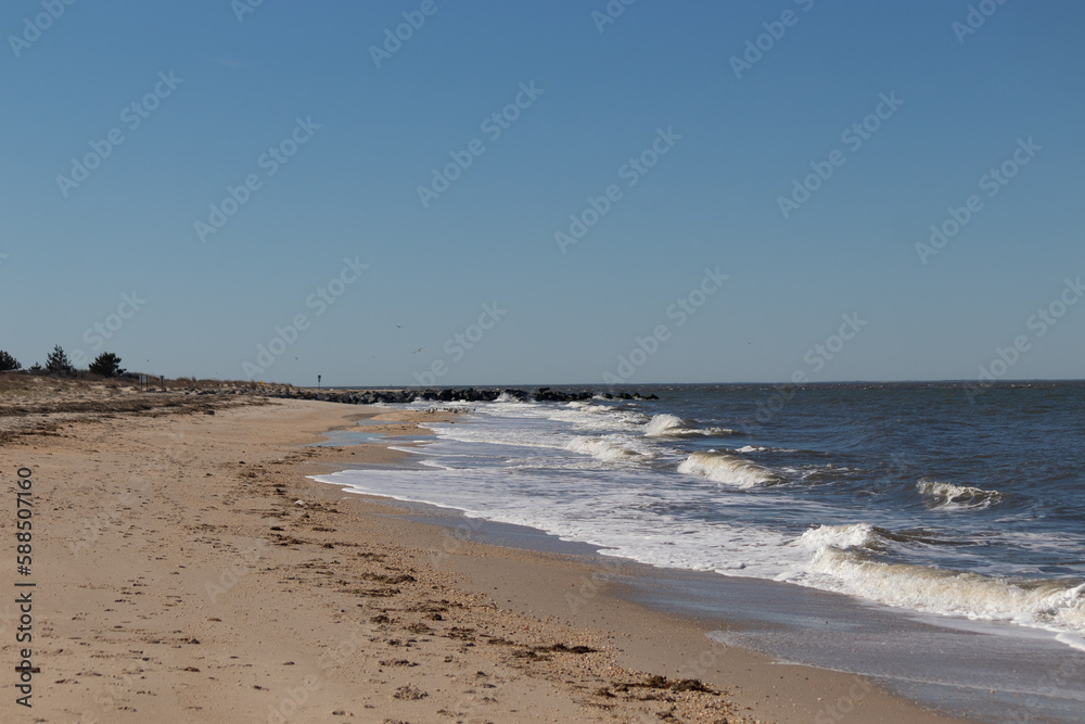 I loved the look of this beach as the waves battered the shore. The whitecaps of the waves make it look rough. The beautiful blue sky with no clouds in site make this look like a beautiful summer day.