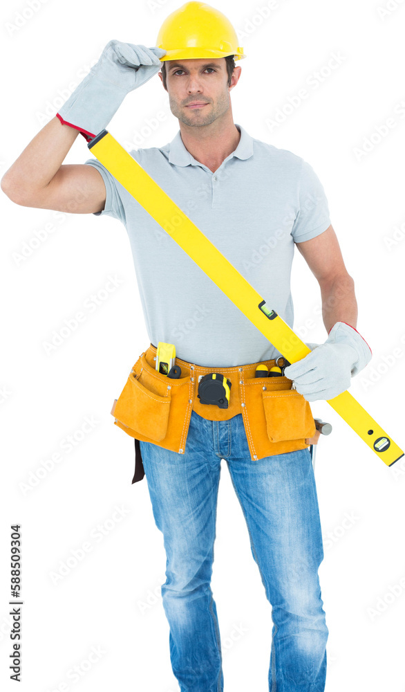 Carpenter holding spirit level while wearing hard hat