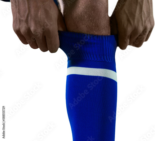 Low section of football player pulling his socks