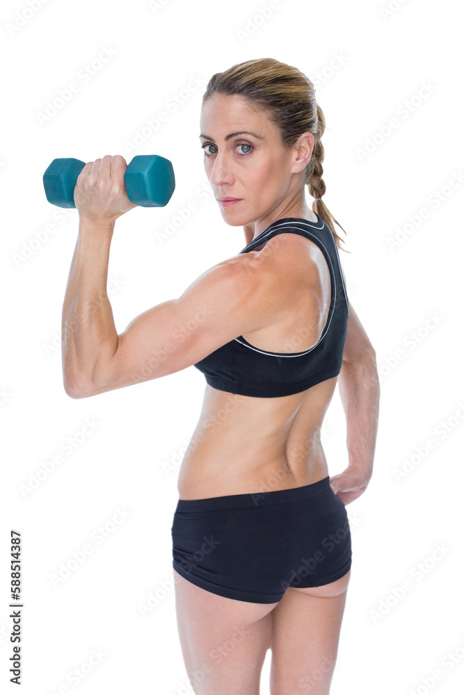 Portrait of confident woman holding dumbbells 