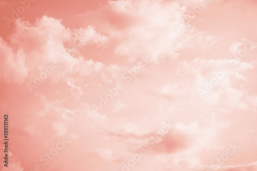 Light pale coral pink sky with white clouds. Tender peach color. Toned sunset. Elegant evening skies background. Gradient. Tropical. Summer. Sun. Romance. Vacation.