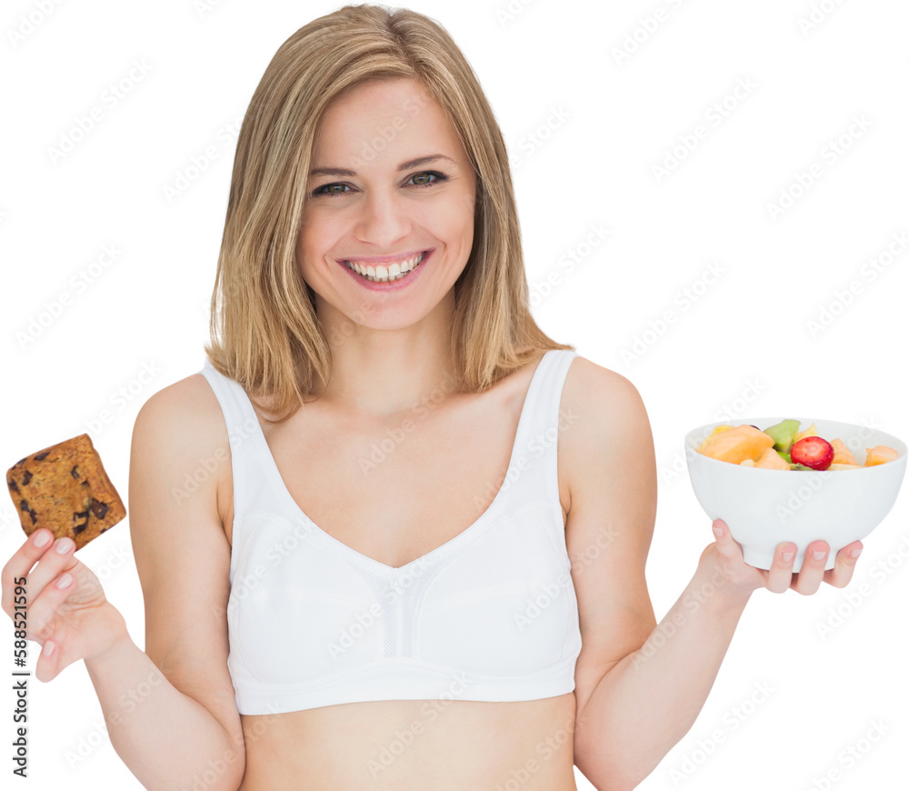 Portrait of happy woman holding cookie and fruit bowl Portrait of happy woman holding cookie and fruit bowl