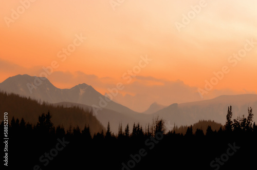 Mountain sunset with orange misty sky