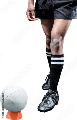 Rugby ball on kicking tee by sportsman