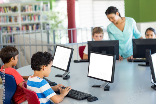 Children using computers as teacher teaching them © vectorfusionart