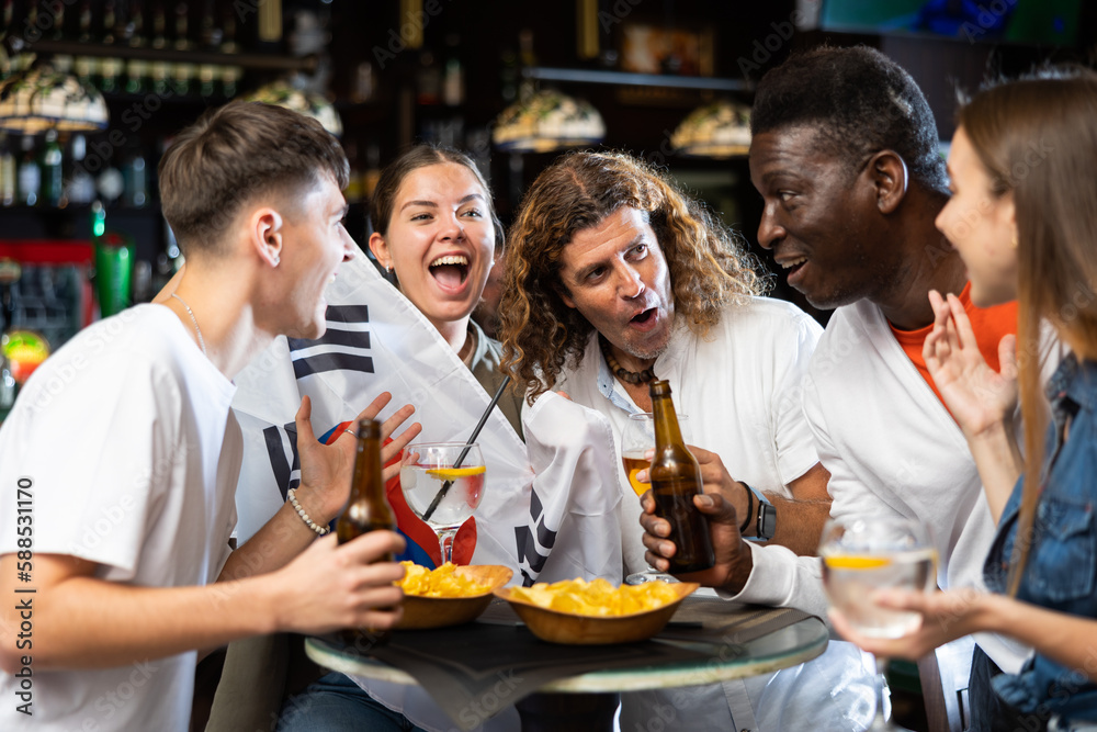 Group of excited football fans having fun in sports bar, celebrating victory of favorite South Korean team together after watching match