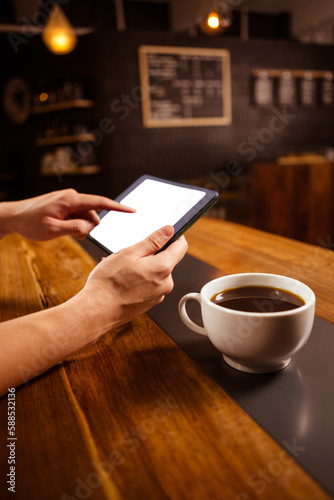 side view of hands using a tablet computer