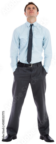 Serious businessman standing with hands in pockets