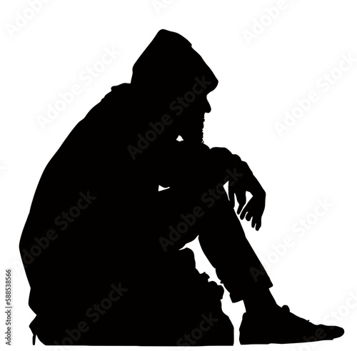 Silhouette of Homeless Hobo Sitting with His Possessions