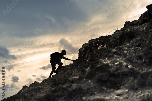Принти на полотні Man climbing up mountain cliff edge. Sport challenge concept