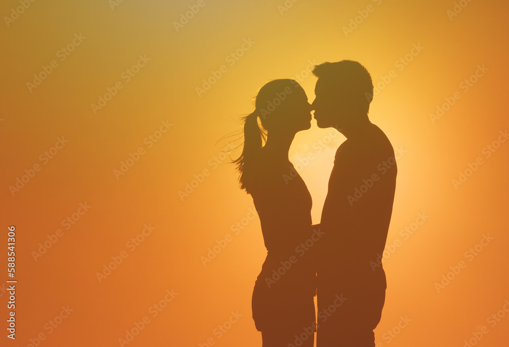 Man and woman in love kissing in the sunset 