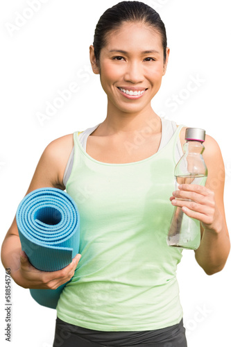 Sporty woman holding exercise mat and water bottle