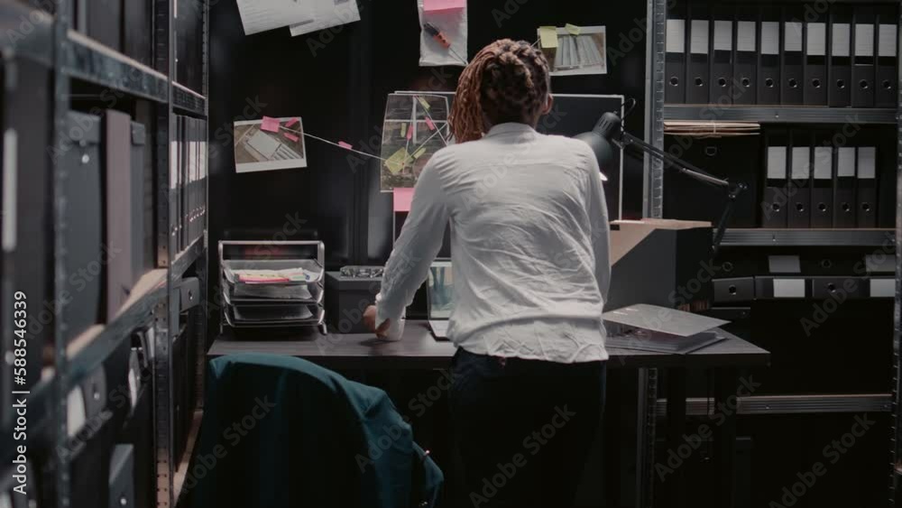 Detective inspector examining case information on map, conducting investigation with physical evidence and surveillance photos. Law agent using detective board to uncover clues or details.