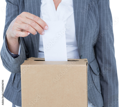 Businesswoman putting ballot in vote box