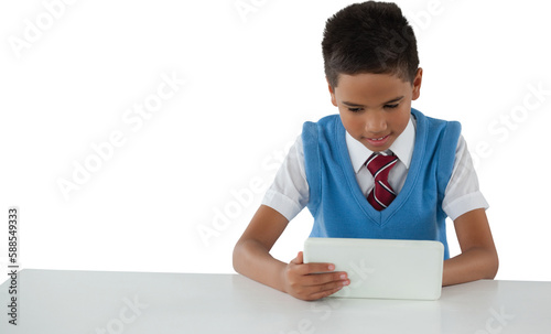 Schoolboy using tablet at table