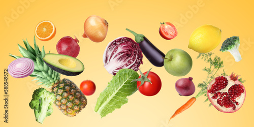 Fototapeta Naklejka Na Ścianę i Meble -  Many fresh vegetables and fruits falling on gold background