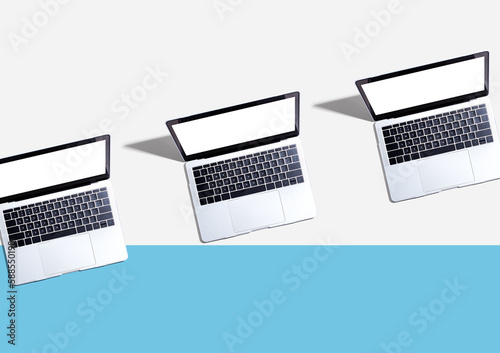 Three laptop computers with shadow - Flat lay