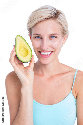Pretty blonde holding half of an avocado 