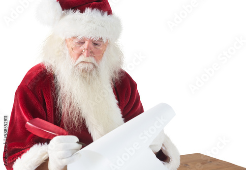 Santa writes something with a feather