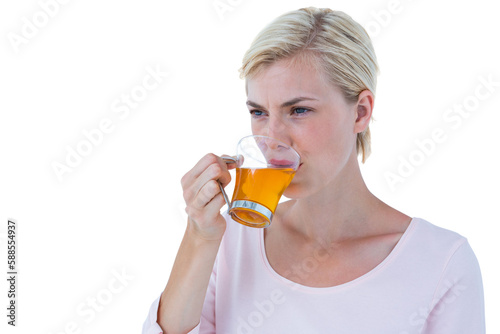 Thoughtful blond woman drinking herbal tea
