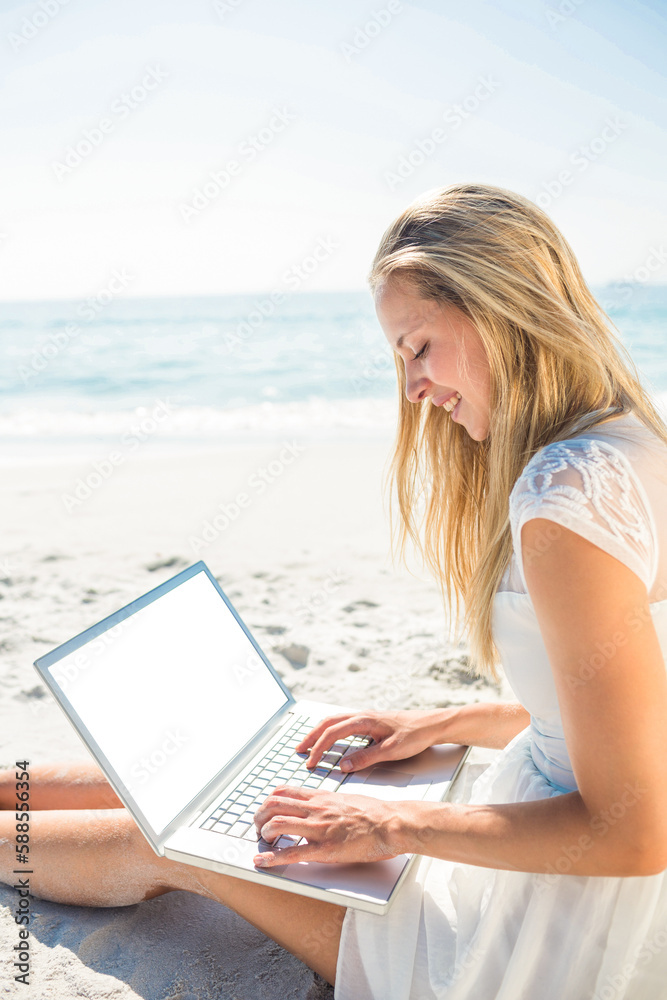  Woman using laptop and wearing hat