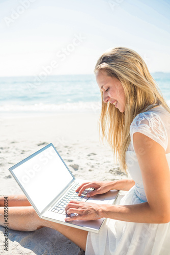  Woman using laptop and wearing hat