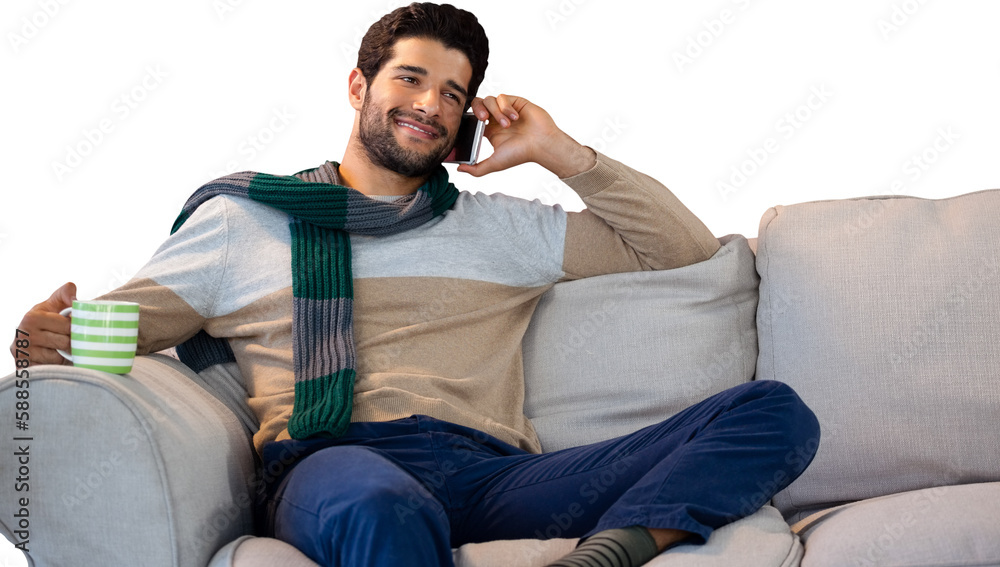 Man talking on phone while having coffee on sofa