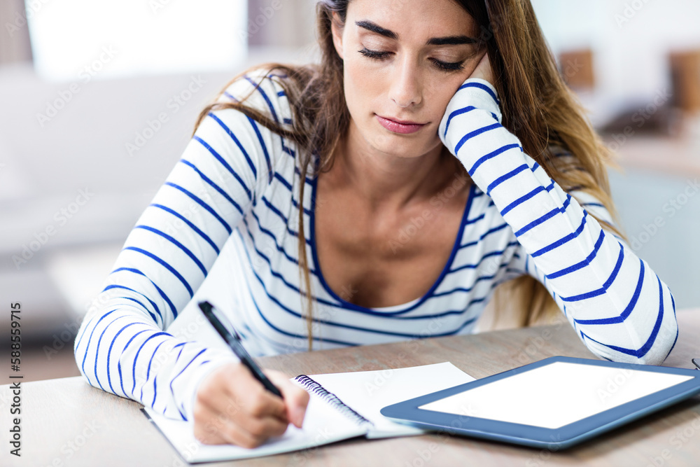 Young woman writing on notebook Young woman writing on notebook