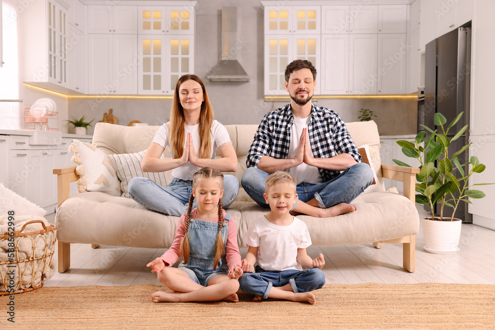 Family meditating together at home. Harmony and zen Family meditating together at home. Harmony and zen