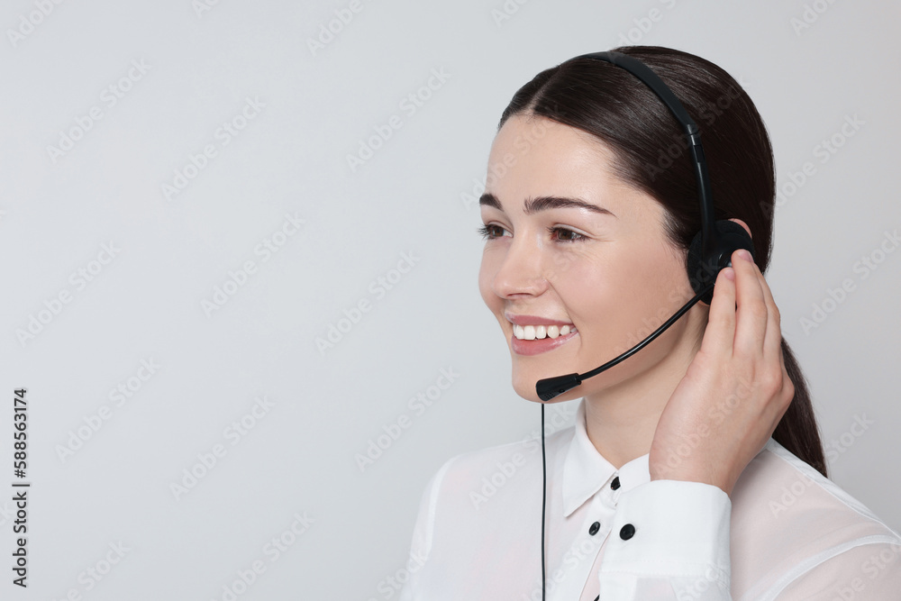 Hotline operator with modern headset on light grey background, space for text. Customer support Hotline operator with modern headset on light grey background, space for text. Customer support