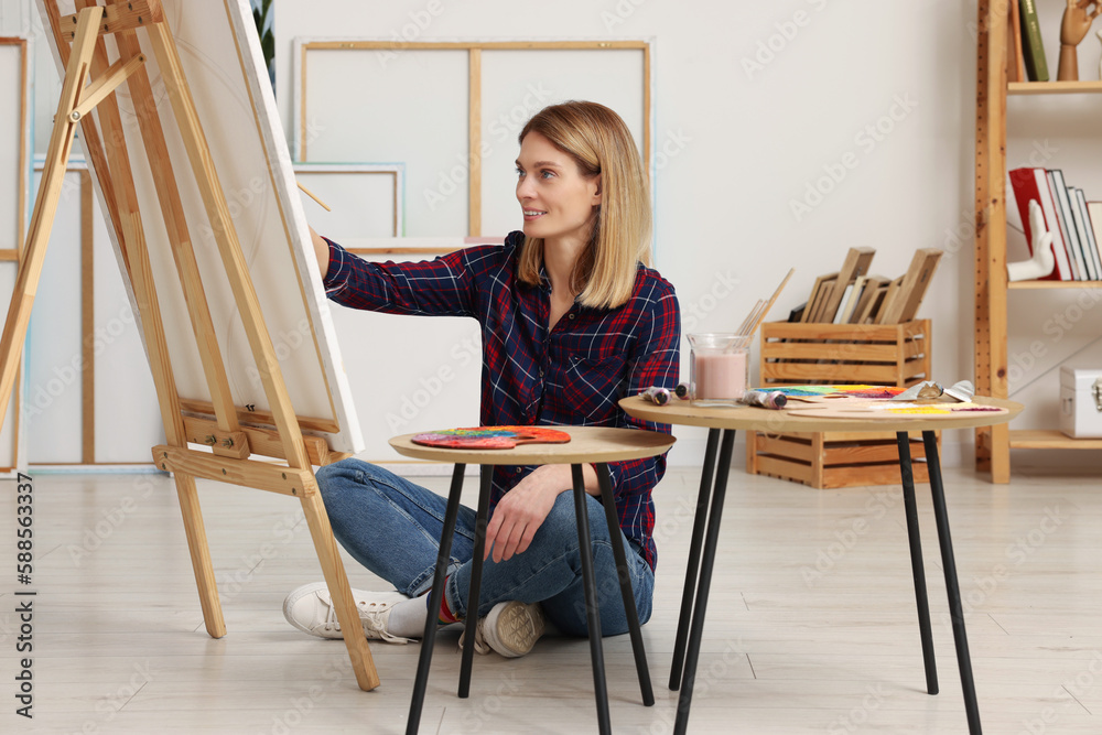 Fototapeta premium Beautiful woman painting in studio. Creative hobby