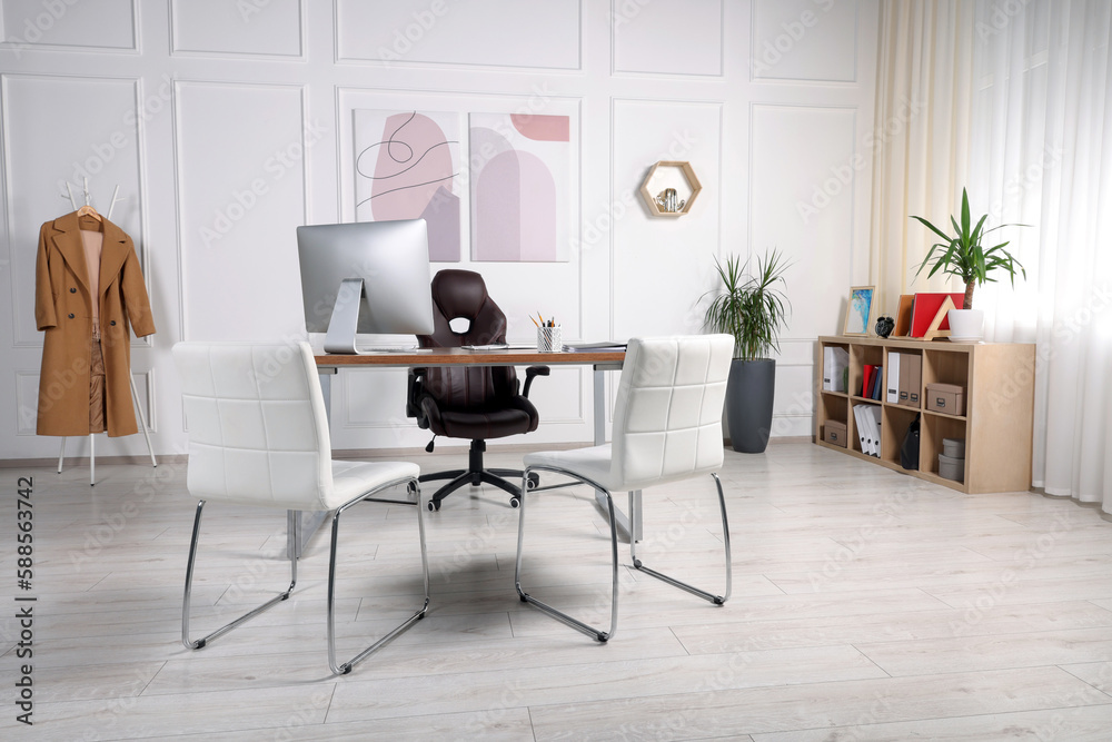 Director's workplace with wooden table, computer and comfortable armchairs. Interior design Director's workplace with wooden table, computer and comfortable armchairs. Interior design