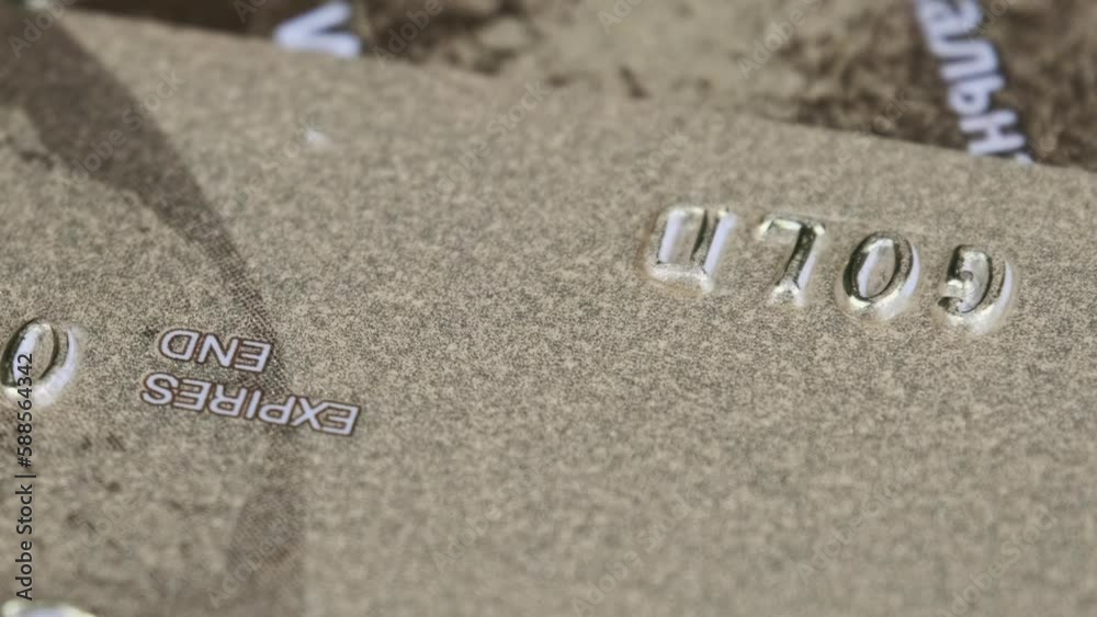 The credit card rotates close up. Plastic bank card spinning in macro