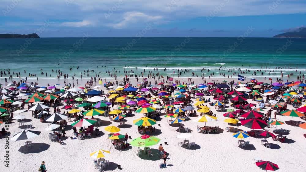 Vista do drone sobre a praia com dunas cheia de turistas e guarda-sol, mar limpo e areia branca na verão na cidade de Cabo Frio, Rio de Janeiro, Brasil Vista do drone sobre a praia com dunas cheia de turistas e guarda-sol, mar limpo e areia branca na verão na cidade de Cabo Frio, Rio de Janeiro, Brasil