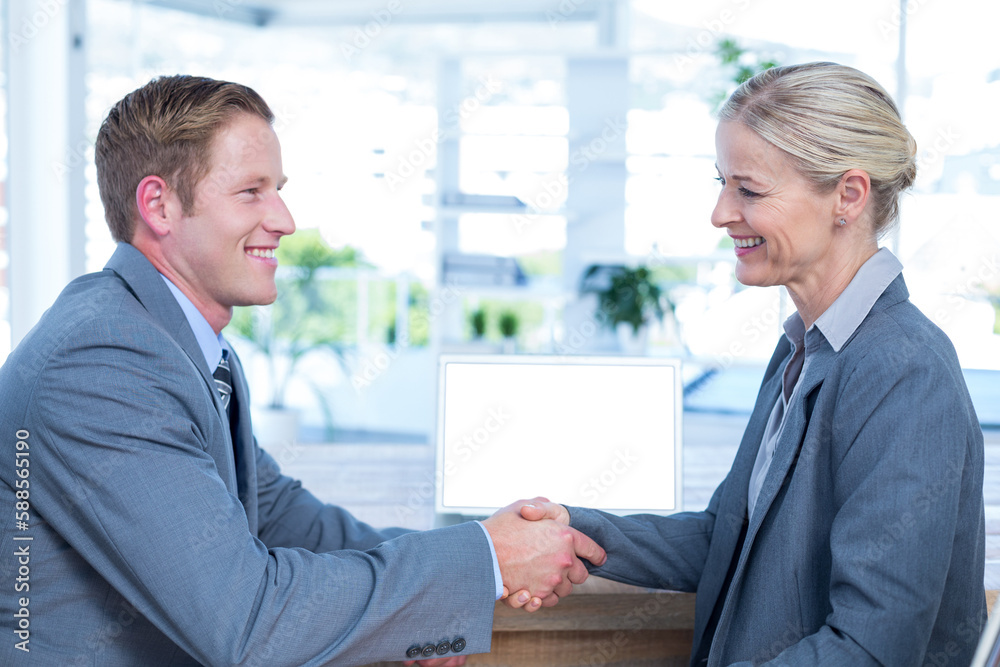 Business people shaking hands in office Business people shaking hands in office