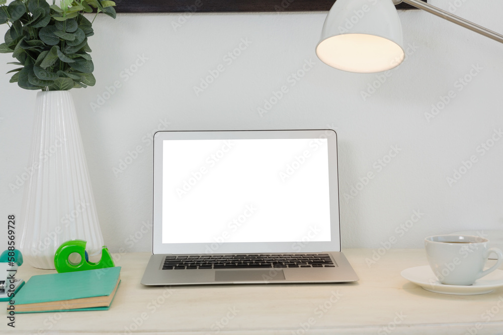 Laptop and various office accessories on table