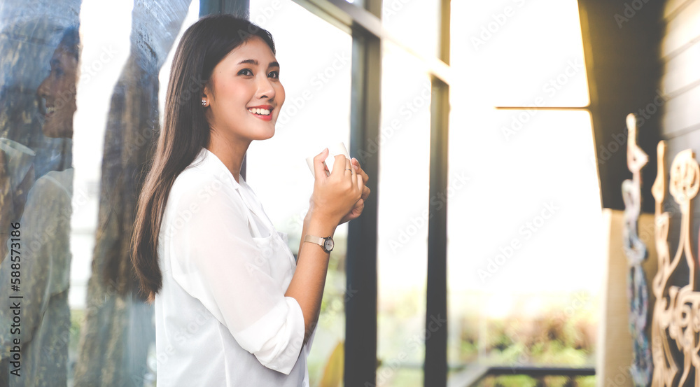 Young Asian woman. Portrait confident asian women smiling holding and drinking hot coffee at home
