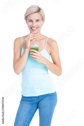 Beautiful woman drinking green juice 
